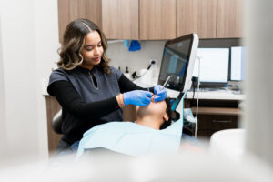 Complete Dental Works dental hygienist showing how teeth make you look younger through consistent professional care