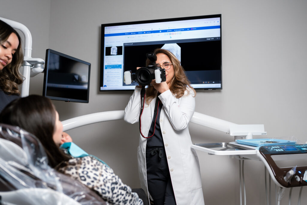 dentist at Complete Dental Works documenting how teeth make you look younger with detailed clinical photography